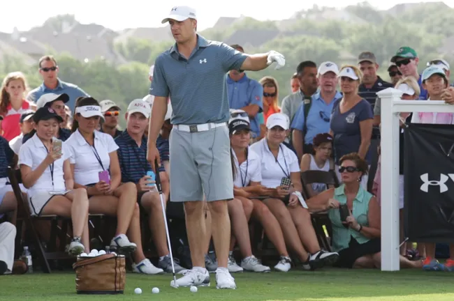 Jordan Spieth stands on a golf course.